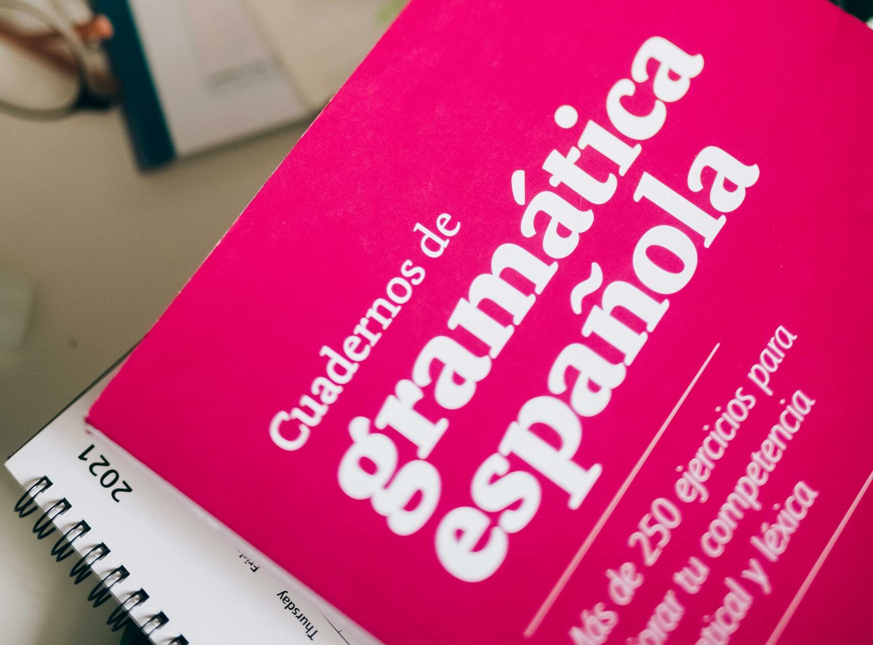 An inviting scene with Spanish grammar notebook and coffee, perfect for study sessions.